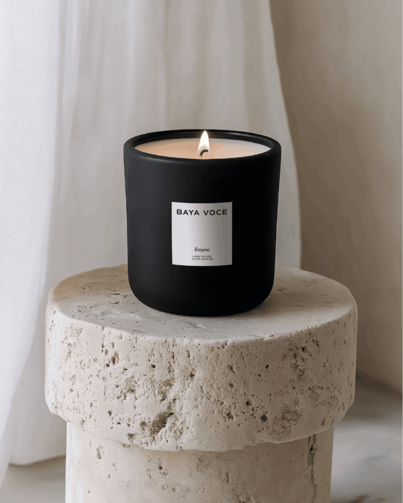 Matte black candle labeled ‘Enigma’ designed for Baya Voce, representing a signature scent concept as part of her immersive brand experience.