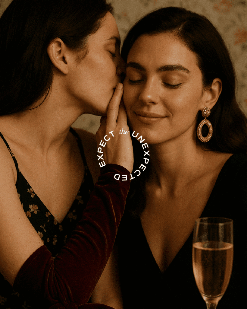 Warm, intimate photo of a woman whispering to another, overlaid with ‘Expect the Unexpected,’ capturing Baya Voce’s seductive brand storytelling.