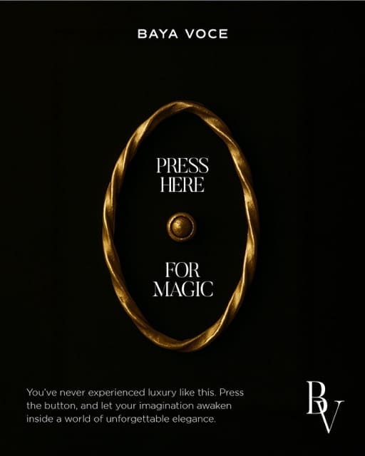 Editorial brand image showing a gold push button with the phrase ‘Press Here for Magic,’ representing the enchantment of Baya Voce’s experience design.