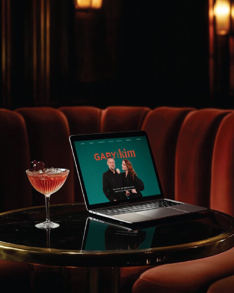 Mockup of Gary and Kim’s homepage on a laptop set against a cocktail lounge backdrop, showing the brand in real-world context.