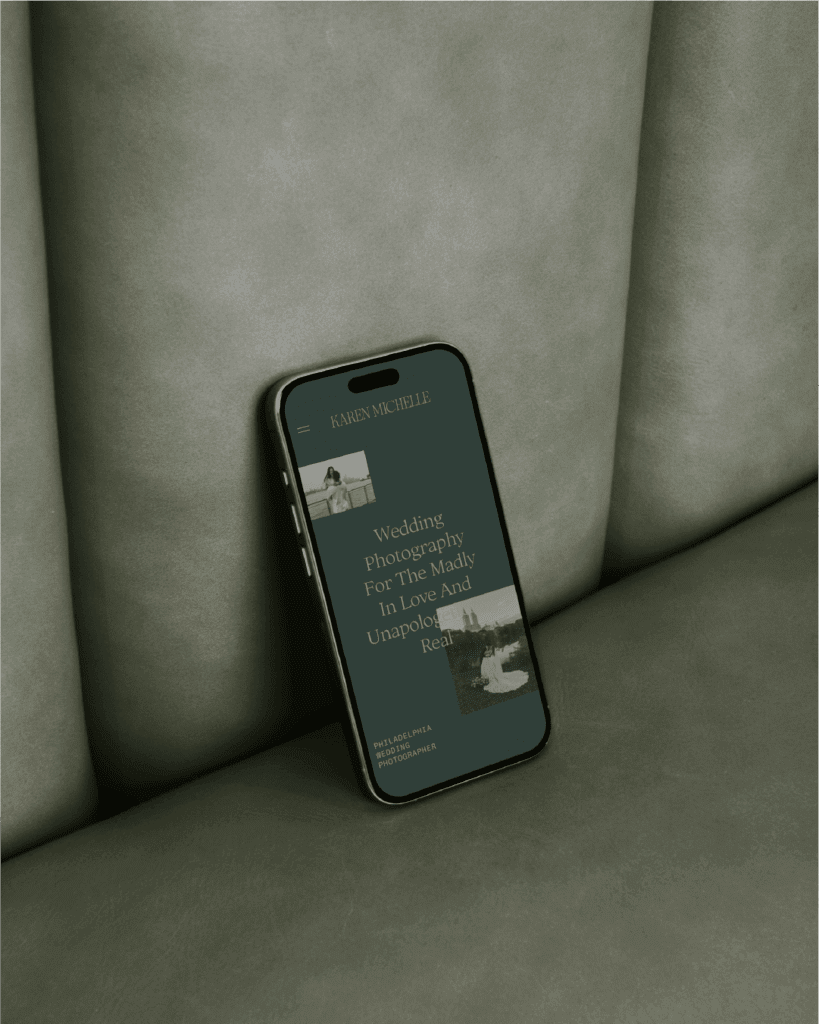 iPhone mockup of Karen's mobile website design sitting on top of a sage green leather couch.