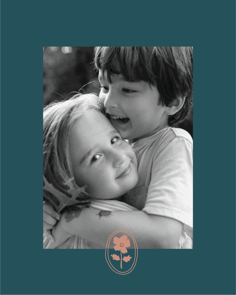 Black and white photo of two children hugging, framed by teal background and Beth Cuddy’s floral brand mark.
